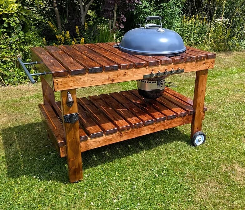 A barbecue table made to order in stained timber, on wheels