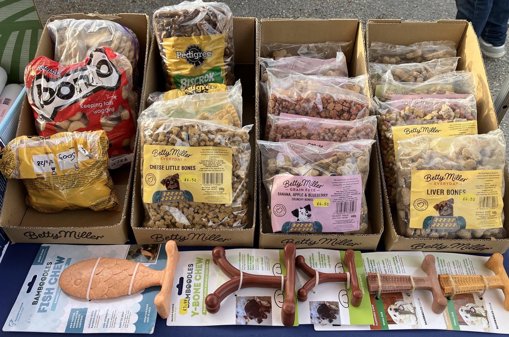 Boxes of hand-baked dog biscuits and a row of durable chew toys